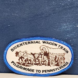 May include: A white oval patch with blue trim, depicting a wagon train with the text "Bicentennial Wagon Train Pilgrimage to Pennsylvania".