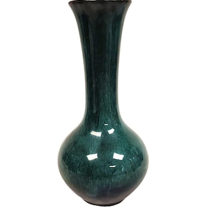 May include: A tall, elegant vase with a glossy, mottled teal and dark green finish. The vase has a rounded base that tapers to a slender neck and a flared rim. The ceramic vase is a decorative home accent.
