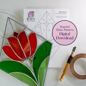 May include: A stained glass pattern for a tulip flower with green leaves. The pattern is printed on white paper and includes numbered sections for cutting and assembling the glass pieces. The image also shows a finished stained glass tulip, a glass cutter, and copper foil tape.