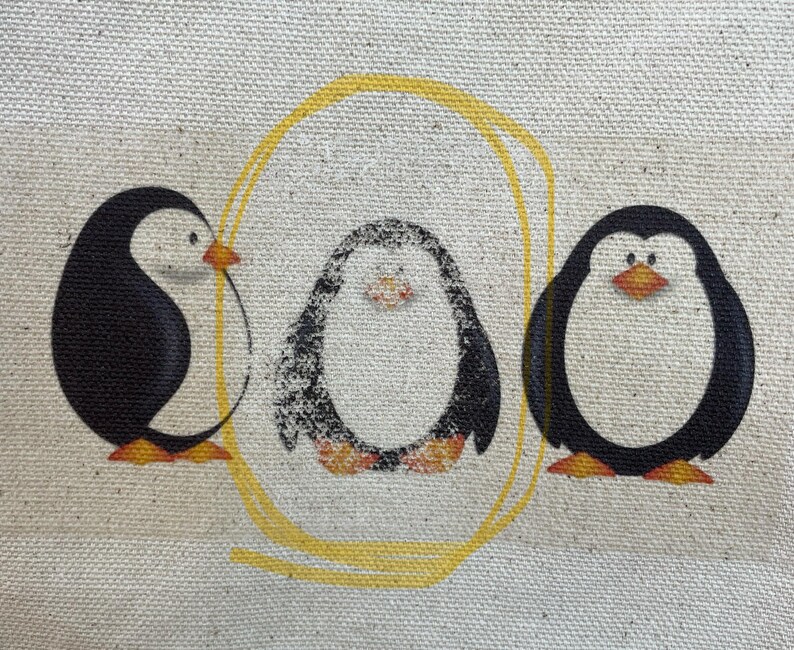 May include: Three black and white penguins with yellow beaks and feet are arranged in a circle on a beige canvas background. A yellow circle surrounds the penguins.