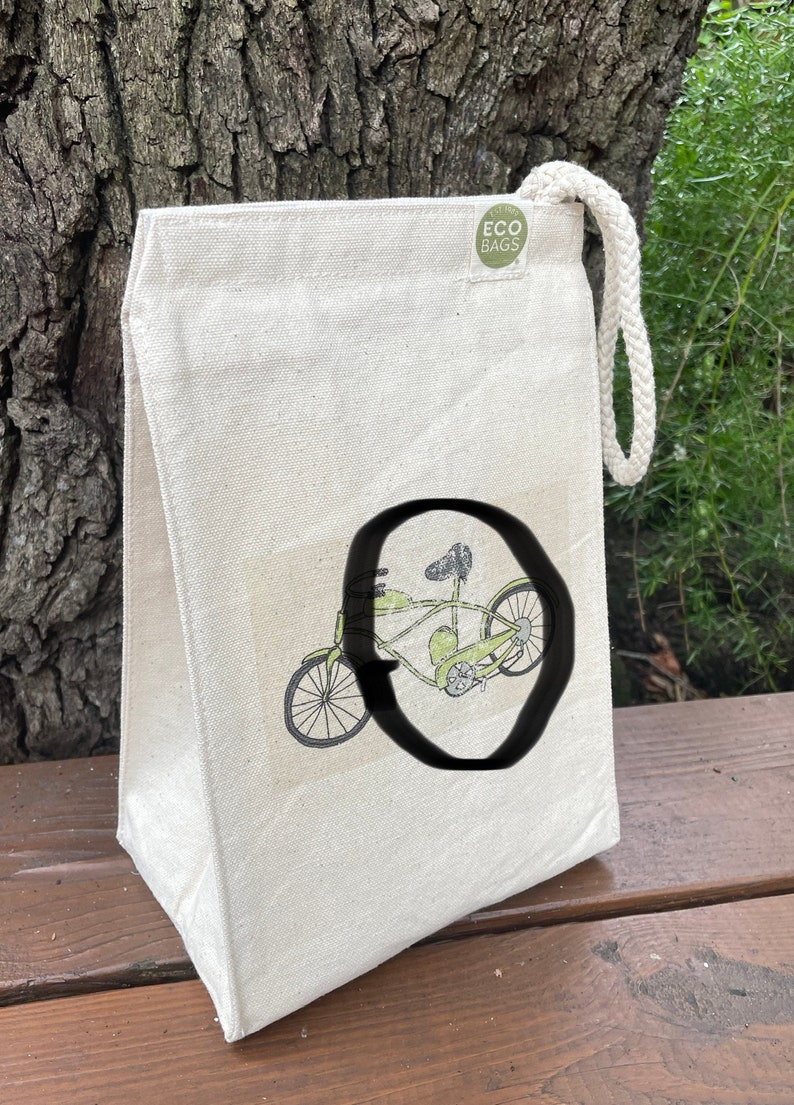 May include: A white canvas tote bag with a green bicycle illustration and the text "ECO BAGS" on a green circle.