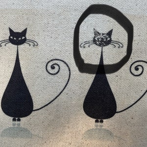 May include: Two black cat silhouettes with curled tails on a beige canvas background. The cat on the right is circled in black.