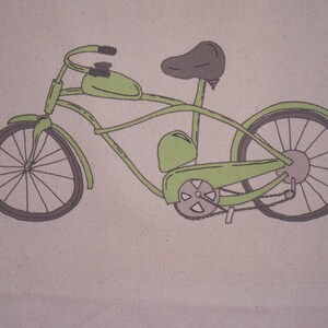 May include: A green bicycle with a brown seat and handlebars. The bicycle has a large, round gas tank and a chain drive.