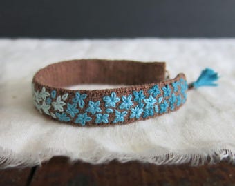 Hand embroidered Linen Cuff Bracelet: Gradient teal floral design on softened brown linen, textile art jewelry, adjustable