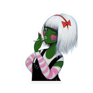May include: A sticker featuring a stylized illustration of a green-skinned figure with white hair and a red bow. The figure is wearing a black overall dress with pink and white striped sleeves and is holding a cigarette.