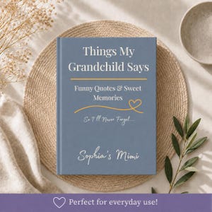 May include: A blue hardcover book titled Things My Grandchild Says, featuring the subtitle Funny Quotes & Sweet Memories, a yellow line with a heart icon, the phrase So I'll Never Forget..., and the personalized name Sophia's Mimi in white text.