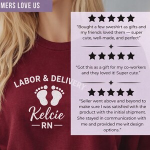 Customer review graphic featuring a maroon Labor & Delivery sweatshirt with white design and embroidered name Kelcie RN alongside five-star reviews.