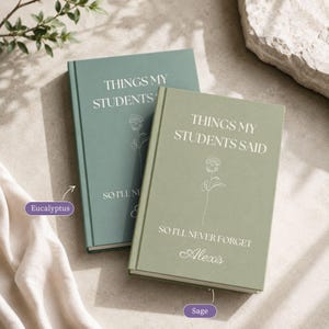May include: Two hardcover journals in eucalyptus and sage green colors. The covers feature the white text "THINGS MY STUDENTS SAID SO I'LL NEVER FORGET" and a line art rose illustration. The sage journal includes the personalized name "Alexis".