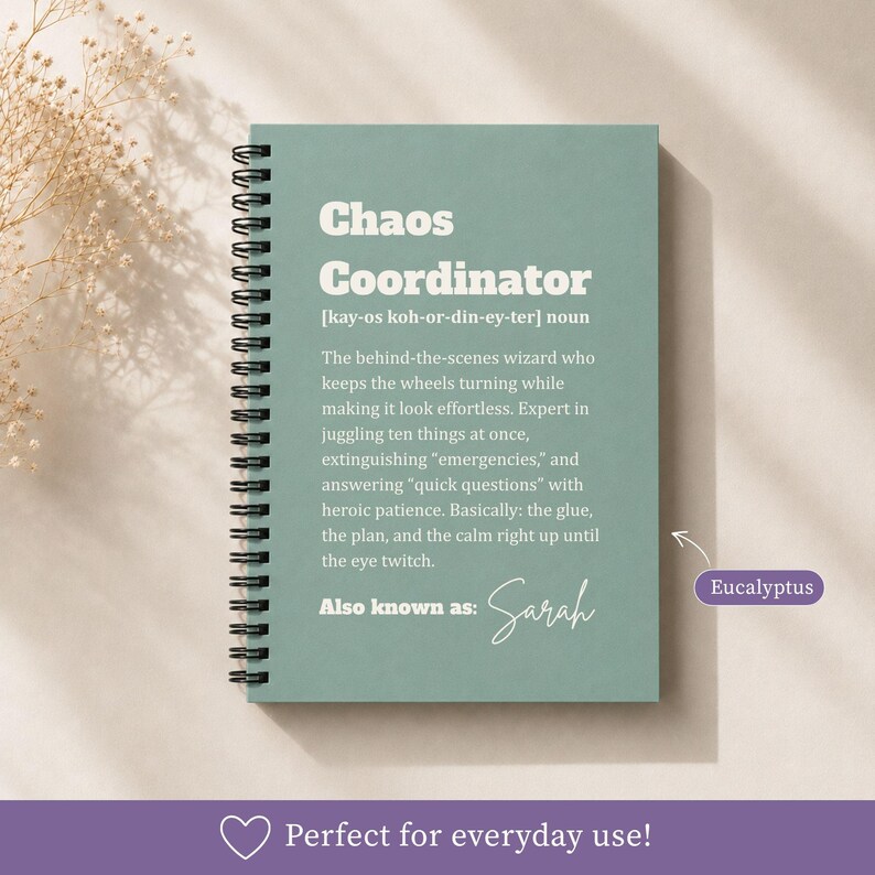 May include: A spiral-bound notebook with a sage green cover featuring white text that defines the term Chaos Coordinator. The text includes a phonetic pronunciation, a humorous definition, and the phrase Also known as: Sarah in script font.