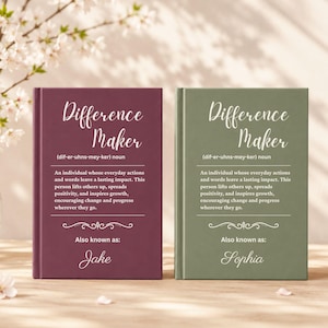 May include: Two hardback books with the title "Difference Maker" in a script font. One book is burgundy, the other is olive green. The text describes a person who inspires growth. The burgundy book is "Also known as: Jake", and the green book is "Also known as: Sophia".