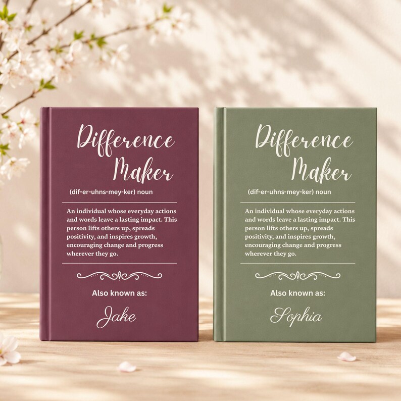 May include: Two hardback books with the title "Difference Maker" in a script font. One book is burgundy, the other is olive green. The text describes a person who inspires growth. The burgundy book is "Also known as: Jake", and the green book is "Also known as: Sophia".