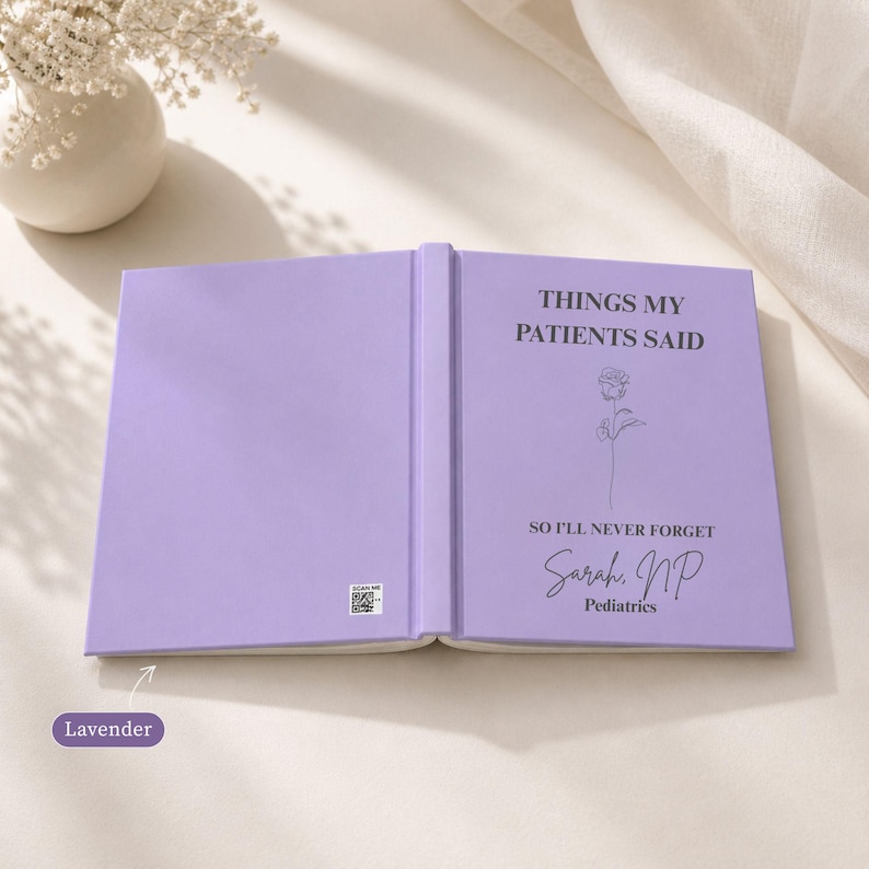 Lavender hardcover Things My Patients Said nurse journal opened to show the front and back cover design, personalized with Sarah NP and Pediatrics, styled with soft neutral decor and floral accents.