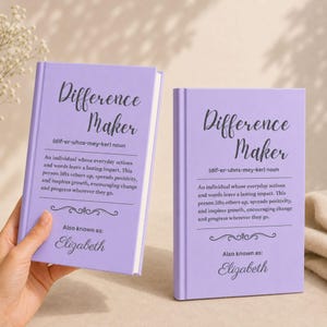 May include: Two lavender-colored books with the title "Difference Maker" in script. The text below defines the term and includes the name "Elizabeth." The books are on a light background.
