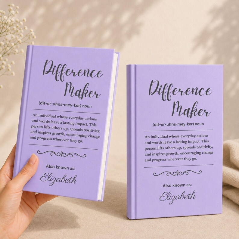 May include: Two lavender-colored books with the title "Difference Maker" in script. The text below defines the term and includes the name "Elizabeth." The books are on a light background.