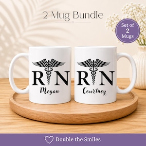 May include: A set of two white ceramic mugs featuring a black caduceus symbol between the letters R and N. The left mug is personalized with the name Megan and the right mug with the name Courtney in black script. Text reads 2 Mug Bundle.