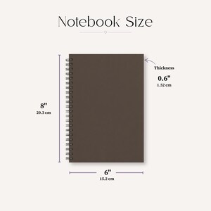 May include: A brown spiral-bound notebook with dimensions displayed. The notebook is 8 inches (20.3 cm) tall, 6 inches (15.2 cm) wide, and 0.6 inches (1.52 cm) thick. The text "Notebook Size" is at the top.