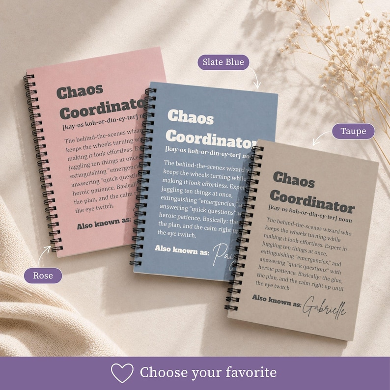 May include: Three spiral-bound notebooks in rose, slate blue, and taupe. Each cover features the text Chaos Coordinator, a phonetic pronunciation, a definition of the role, and the phrase Also known as, with space for a name to be added.