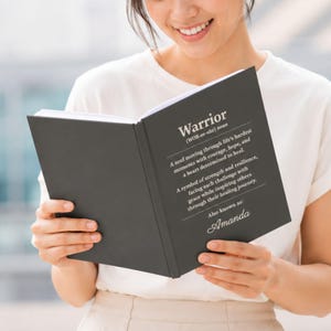 Charcoal personalized healing journal featuring a Warrior definition cover, custom name, and inspirational recovery message. Thoughtful cancer survivor gift, recovery notebook, encouragement journal, patient support keepsake, or treatment journal for someone facing a hard season with courage, hope, strength, and resilience.