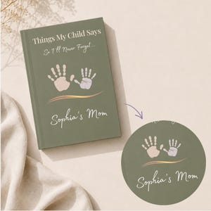 May include: A sage green hardback journal with the text Things My Child Says So I'll Never Forget printed in white. The cover features two light-coloured handprints above a gold wavy line and the personalised name Sophia's Mom in white script.
