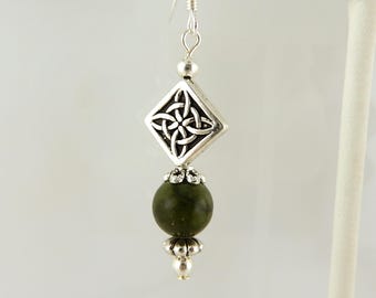 May include: Silver Celtic knot earrings with a green stone bead.