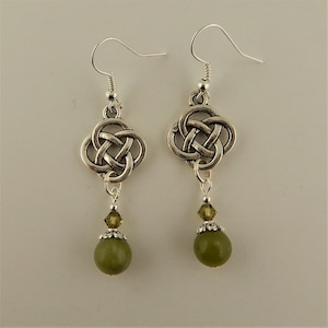 May include: Silver Celtic knot earrings with green glass beads and crystal accents.