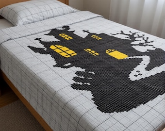 May include: A white bedspread featuring a black pixelated haunted house design with yellow windows and a ghost figure. The fabric has a thin black grid pattern throughout, covering the mattress and a matching pillow with the same grid design.