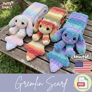May include: Three handmade, colorful Gremlin scarves in pastel rainbow hues. Each scarf features a plush bunny head and body, with long ears and a tail. The scarves are displayed on a wooden surface.