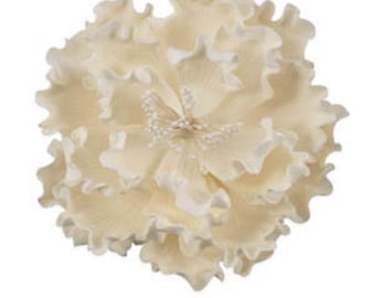 May include: A cream-colored, artificial flower with multiple layers of ruffled petals. The center features a cluster of small, white, bead-like details. The flower is designed to resemble a peony, with a soft, delicate appearance.