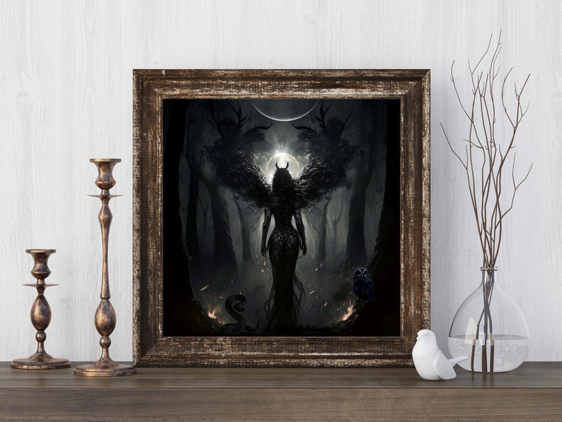 May include: A framed print of a dark fantasy illustration featuring a winged woman with horns standing in a forest. The woman is wearing a dark dress and has a glowing halo behind her. The forest is dark and mysterious, with trees and branches reaching up towards the sky. There is a snake and an owl in the foreground.