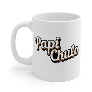 May include: White ceramic coffee mug with the text "Papi Chulo" in a black, orange, and white retro font. The mug has a curved handle and a glossy finish.