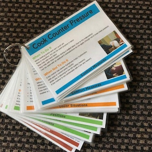 May include: A set of flashcards on a metal ring, with titles like "Cook Counter Pressure", "Comfort Measures", and "Labor Situations". The cards have blue, orange, green, and red accents, with text and images.
