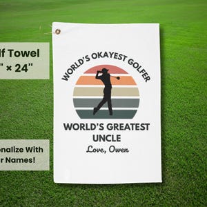 May include: White golf towel with a retro-style design featuring a silhouette of a golfer and the text "World's Okayest Golfer" and "World's Greatest Uncle". The towel is 16 inches by 24 inches.