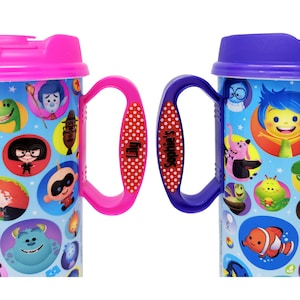 May include: Two plastic travel mugs with lids and handles. The left mug has a pink lid and handle with the name Lily printed on it. The right mug has a purple lid and handle with the name Sophie's printed on it. Both feature colorful Disney characters.