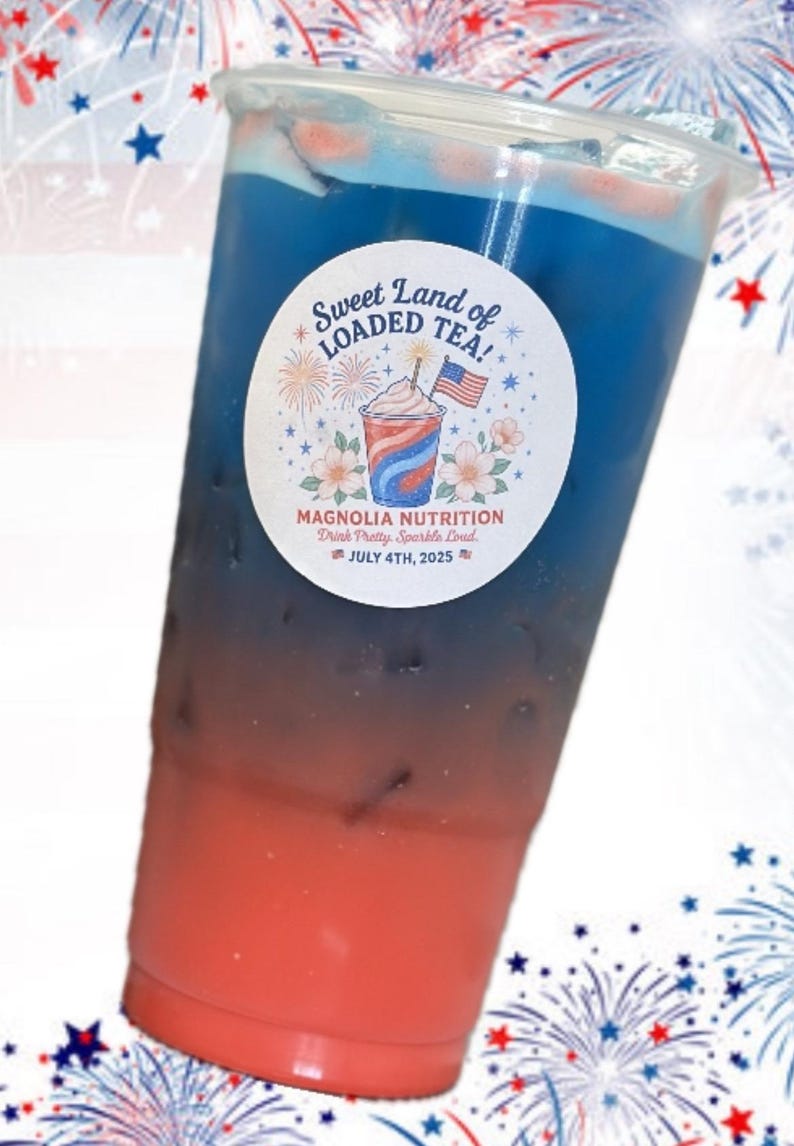 May include: A clear plastic cup filled with a layered red and blue iced beverage. A circular white sticker on the front features the text Sweet Land of LOADED TEA! MAGNOLIA NUTRITION Drink Pretty. Sparkle Loud. JULY 4TH, 2025 with a graphic of a drink.