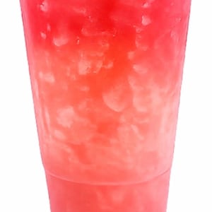 May include: A clear plastic disposable cup filled with a vibrant red liquid and a large amount of crushed ice. The cup features a transparent lid and a tapered design, showcasing the bright red beverage and the texture of the ice inside.