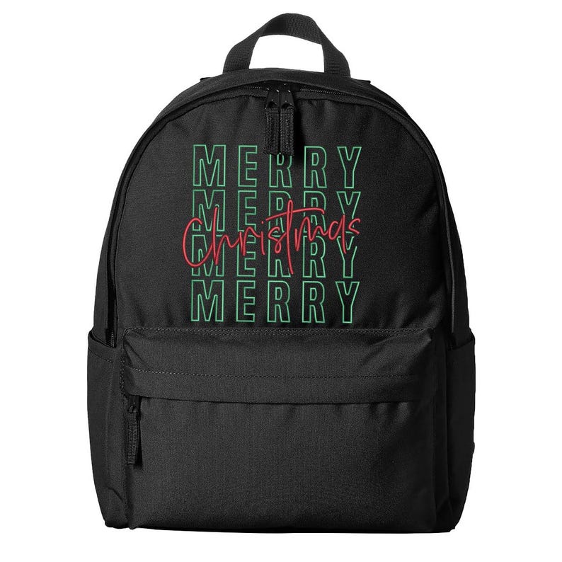 May include: Black backpack with a front pocket and top handle. The backpack features the words "MERRY CHRISTMAS" in green and red lettering. The word "MERRY" is stacked four times in green, with "Christmas" in a cursive red font.