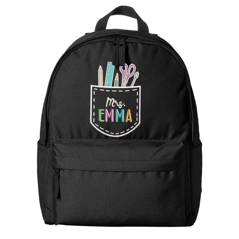 May include: Black backpack with a front pocket featuring school supplies and the text "Mrs. Emma" in colorful letters. The pocket design includes pencils, a ruler, and scissors. The backpack has a top handle and a zippered main compartment.