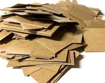 May include: A pile of brown cardboard squares, likely for crafting or scrapbooking.
