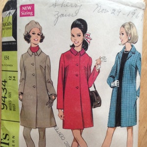 May include: A vintage sewing pattern for a coat, featuring three women wearing different styles of coats. The pattern is from McCall's and is numbered 9434. The pattern is dated November 29, 1961.