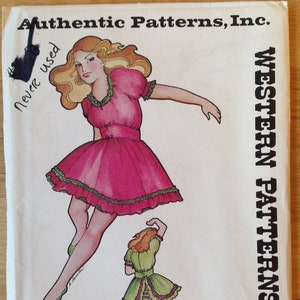 May include: A vintage sewing pattern for a Western-style dress. The pattern is for a girl's dress and includes two figures, one in a pink dress and one in a green dress. The pattern number is 261. The pattern is marked "Never Used".