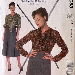 May include: McCall's sewing pattern from The Archive Collection, circa 1933. The pattern features a woman in a blouse and skirt. The blouse has a floral pattern, and the skirt is gray. The pattern number is M7053, size E5.