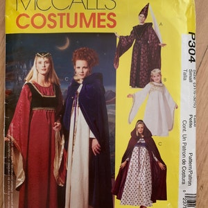 May include: McCall's Costumes sewing pattern for three medieval-style costumes. The pattern includes a purple hooded cloak, a white hooded gown, and a red gown with a black bodice. The pattern is for size small, petite.