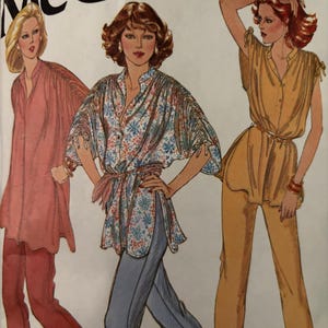 May include: Vintage McCall's sewing pattern showing three women's outfits. The outfits include a pink tunic and trousers, a floral print top with blue trousers, and a yellow top and trousers. The pattern is labeled "Carefree Patterns" and "McCall's".