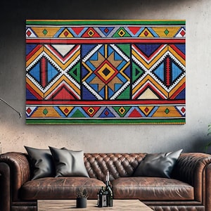 May include: A rectangular wall art piece featuring a vibrant geometric pattern composed of repeating diamonds, triangles, and horizontal stripes in bold shades of red, blue, yellow, green, and white, creating a symmetrical and intricate visual design.