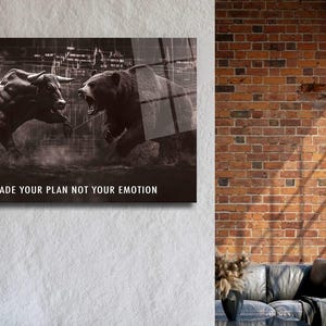 May include: Monochrome artwork showing a bull and a bear in a confrontational pose, set against a backdrop of a city skyline and financial data. The text reads "TRADE YOUR PLAN NOT YOUR EMOTION".