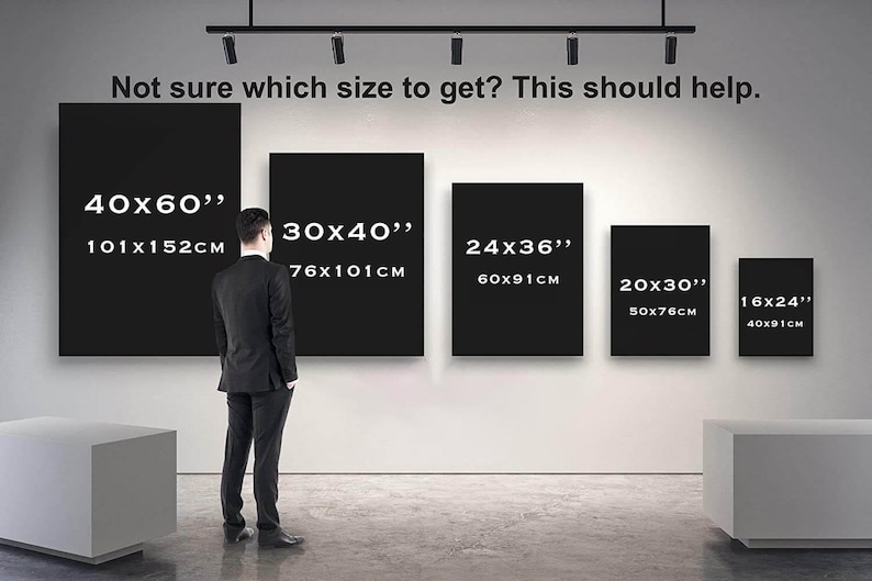 May include: A person in a suit stands in front of a wall with black rectangular art pieces of different sizes. The text above says, "Not sure which size to get? This should help." Sizes are shown in inches and cm, including 40x60", 30x40", 24x36", 20x30", and 16x24".