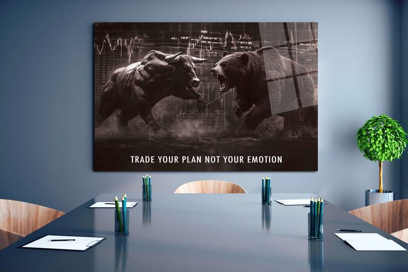 May include: A monochrome print depicting a bull and a bear in a confrontational pose, set against a stock market backdrop. The text "TRADE YOUR PLAN NOT YOUR EMOTION" is displayed. The artwork is mounted on a wall above a conference table.