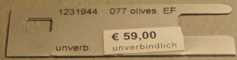 May include: A silver-colored metal tag with the numbers "1231944" and "077 olives. EF" printed on it. A white sticker with the price "&euro; 59,00" is attached. The word "unverb." is printed on the tag.
