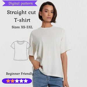May include: A woman wearing a cream-colored, short-sleeved T-shirt and blue jeans. The image includes text that reads "Digital pattern Straight cut T-shirt Sizes XS-3XL Beginner Friendly". A line drawing of the T-shirt is also shown.