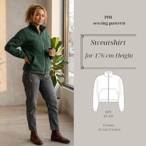 May include: A woman wearing a dark green zip-up sweatshirt with pockets, paired with gray jeans and brown boots. The image includes a PDF sewing pattern for a sweatshirt, designed for a height of 176 cm, with sizes XS-3XL.